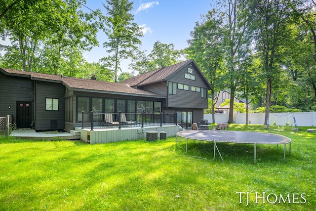 2605 Shadowbrook Dr SE, Grand Rapids, MI 49546 - back of house featuring a trampoline, a chimney, a sunroom, and central air condition unit