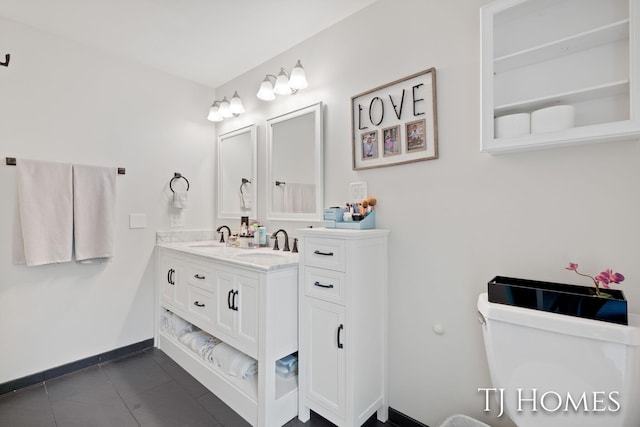 2605 Shadowbrook Dr SE, Grand Rapids, MI 49546 - bathroom with double vanity, toilet, tile patterned floors, and baseboards