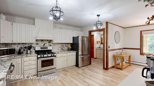 2258 High Rd, Roscommon, MI 48653 - kitchen with stainless steel appliances, a baseboard heating unit, light wood-style flooring, custom range hood, and backsplash