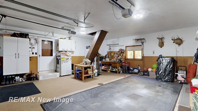 2258 High Rd, Roscommon, MI 48653 - garage with a garage door opener and freestanding refrigerator