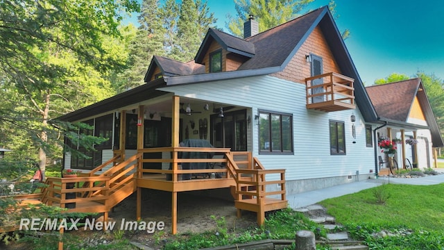 2258 High Rd, Roscommon, MI 48653 - back of house with a sunroom, a chimney, roof with shingles, and a lawn