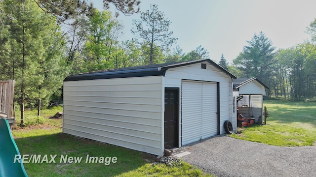 2258 High Rd, Roscommon, MI 48653 - garage featuring a storage unit