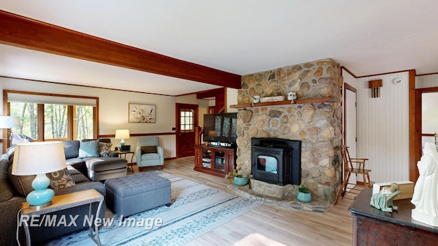 2258 High Rd, Roscommon, MI 48653 - living area featuring light wood-type flooring, beam ceiling, and a wood stove