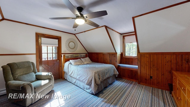 2258 High Rd, Roscommon, MI 48653 - carpeted bedroom featuring multiple windows, a wainscoted wall, lofted ceiling, wooden walls, and ceiling fan