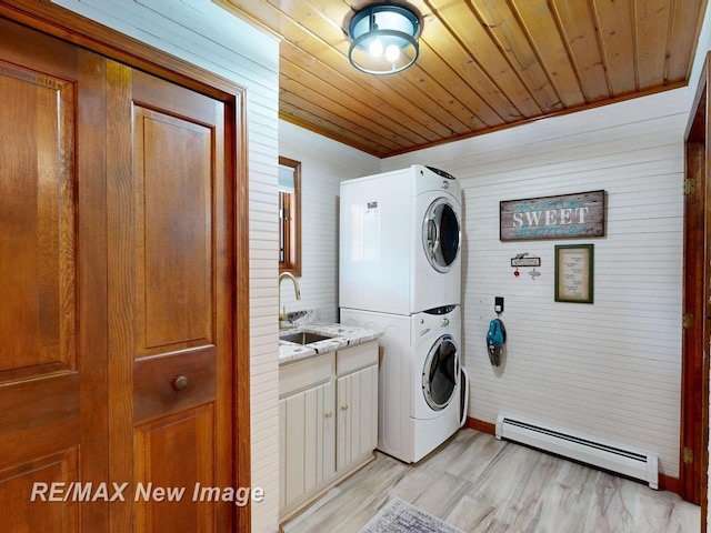 2258 High Rd, Roscommon, MI 48653 - laundry room featuring a baseboard heating unit, stacked washer / dryer, cabinet space, light wood-style flooring, and wood ceiling