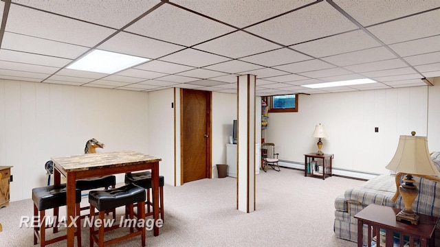 2258 High Rd, Roscommon, MI 48653 - recreation room featuring carpet floors, a baseboard heating unit, and a paneled ceiling