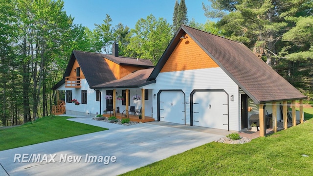 2258 High Rd, Roscommon, MI 48653 - view of front of home with a porch, a chimney, a garage, concrete driveway, and a front lawn