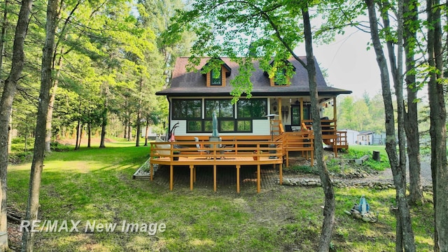 2258 High Rd, Roscommon, MI 48653 - back of house featuring a deck and a lawn