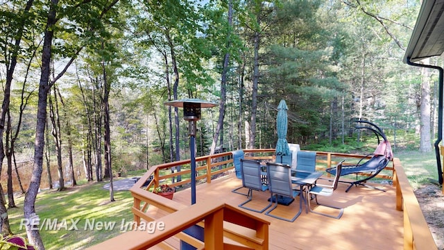 2258 High Rd, Roscommon, MI 48653 - wooden terrace with outdoor dining area and a view of trees