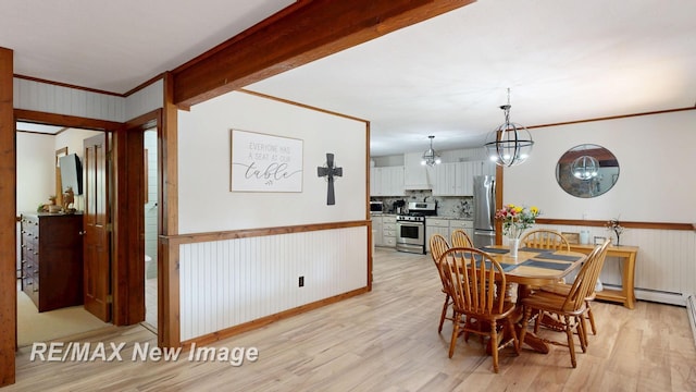 2258 High Rd, Roscommon, MI 48653 - dining space featuring crown molding, light wood-style floors, wainscoting, a chandelier, and a baseboard radiator