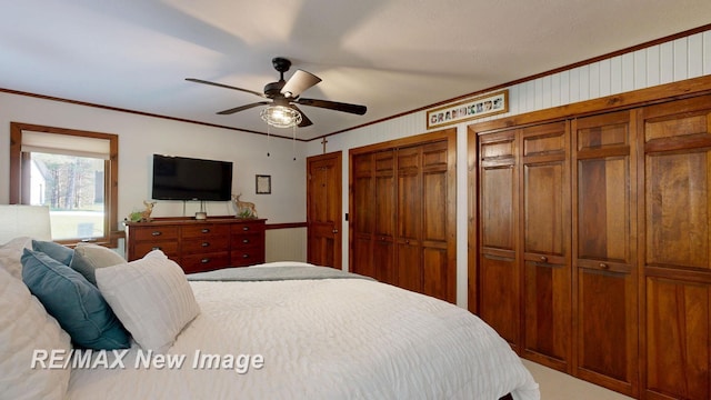 2258 High Rd, Roscommon, MI 48653 - bedroom with crown molding, ceiling fan, carpet floors, and two closets