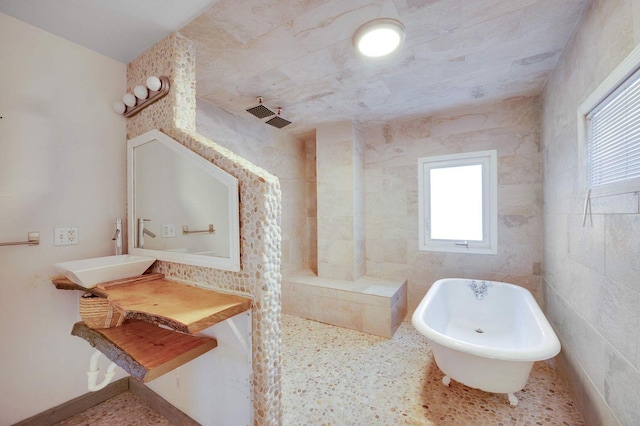 617 Elm St, Saint Joseph, MI 49085 - bathroom featuring a sink, a freestanding bath, and a walk in shower