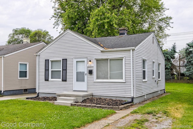 22811 Sharrow Ave, Utica, MI 48089 - bungalow-style house with a front lawn, a chimney, and a shingled roof