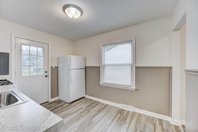 22811 Sharrow Ave, Utica, MI 48089 - kitchen featuring freestanding refrigerator, wainscoting, light wood-type flooring, and light countertops