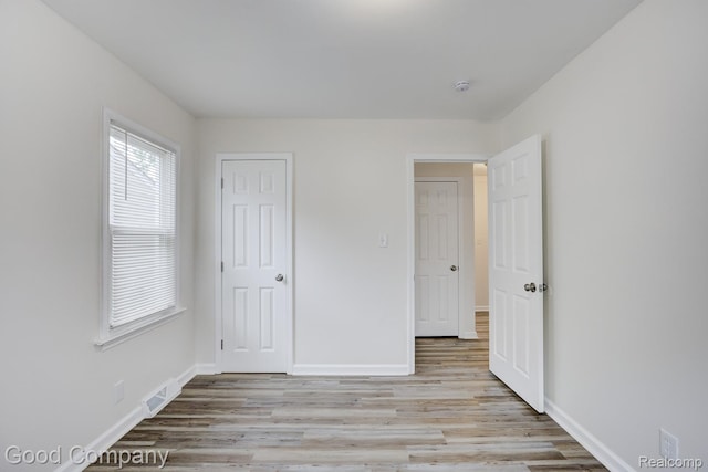 22811 Sharrow Ave, Utica, MI 48089 - unfurnished bedroom with light wood-type flooring and baseboards