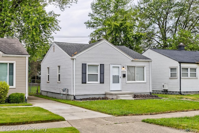 22811 Sharrow Ave, Utica, MI 48089 - bungalow-style house featuring a front yard and a shingled roof