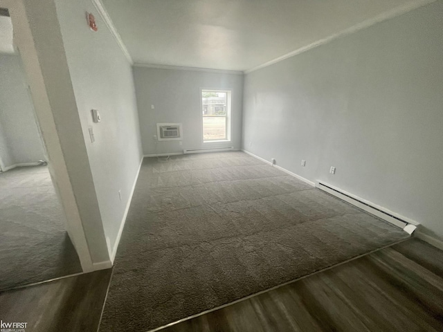 11009 N Saginaw St, Mount Morris, MI 48458 - carpeted empty room with a baseboard heating unit, crown molding, baseboards, and wood finished floors