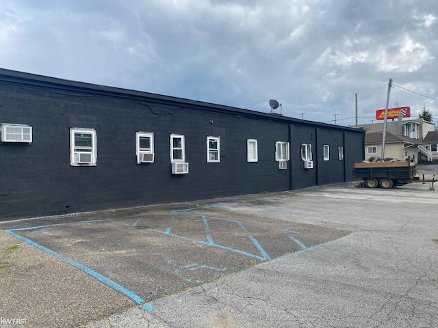 11009 N Saginaw St, Mount Morris, MI 48458 - view of building exterior with cooling unit and uncovered parking