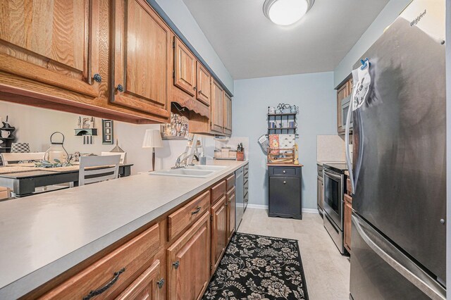 3431 Brookview Ct, Hudsonville, MI 49426 - kitchen with stainless steel appliances, a sink, brown cabinets, light countertops, and baseboards