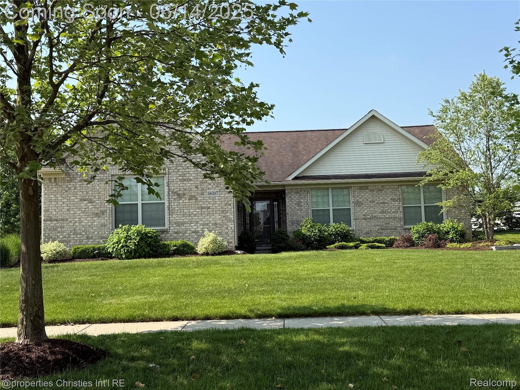 58307 Holland Dr, South Lyon, MI 48178 - view of front facade with brick siding and a front lawn