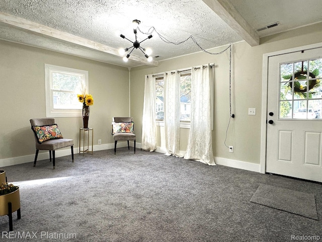 311 S Foster Ave, Lansing, MI 48912 - living area featuring a textured ceiling, a chandelier, carpet floors, baseboards, and beamed ceiling
