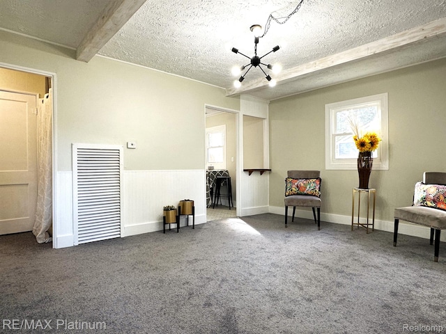 311 S Foster Ave, Lansing, MI 48912 - living area with a chandelier, plenty of natural light, carpet floors, and a textured ceiling