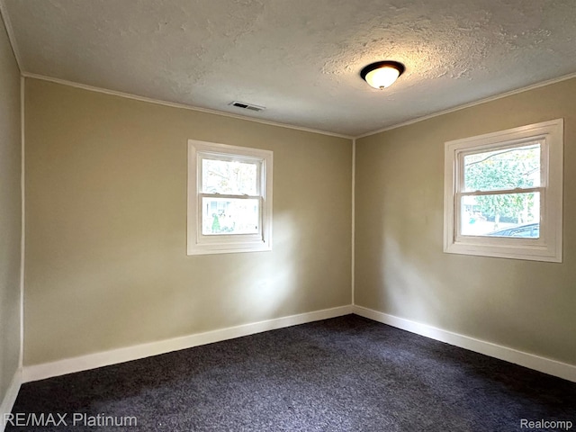 311 S Foster Ave, Lansing, MI 48912 - empty room with healthy amount of natural light, baseboards, a textured ceiling, dark carpet, and crown molding
