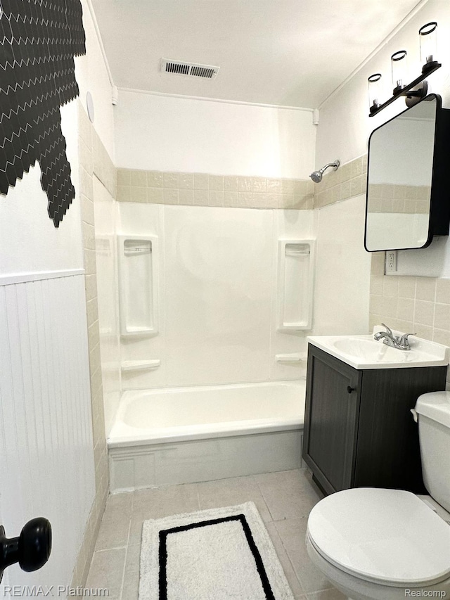 311 S Foster Ave, Lansing, MI 48912 - bathroom with toilet,  shower combination, vanity, tasteful backsplash, and tile patterned floors