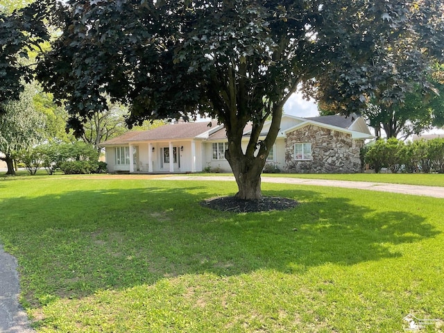 4845 E Dunbar Rd, Monroe, MI 48161 - ranch-style house with a front yard and stone siding