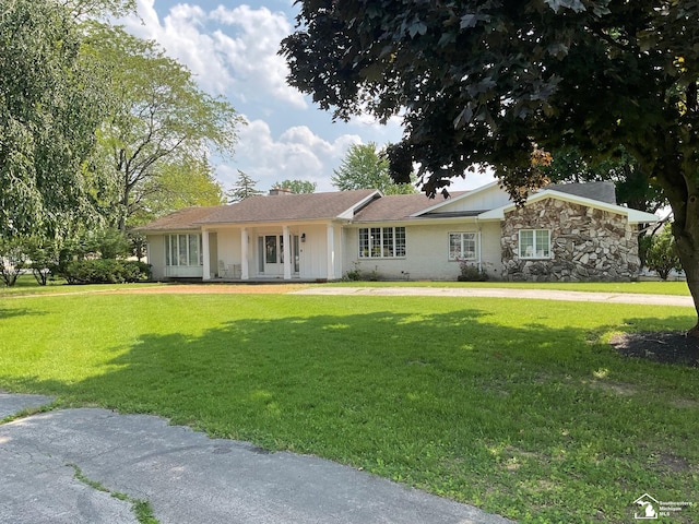 4845 E Dunbar Rd, Monroe, MI 48161 - ranch-style home with a front yard, a chimney, covered porch, and stone siding
