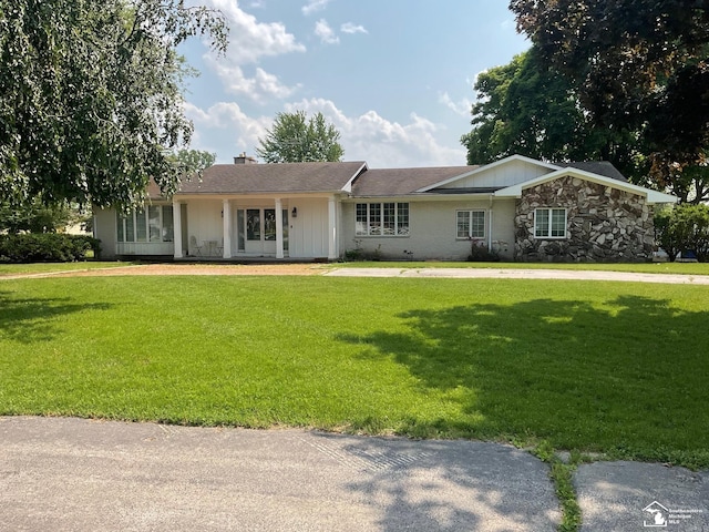 4845 E Dunbar Rd, Monroe, MI 48161 - ranch-style home with a front lawn, a chimney, board and batten siding, and stone siding