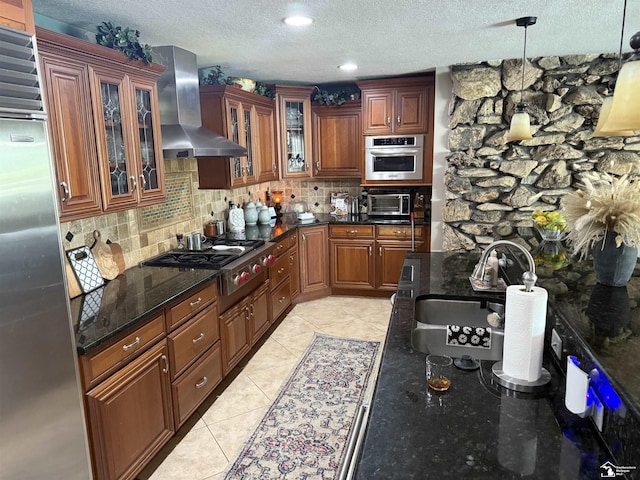 4845 E Dunbar Rd, Monroe, MI 48161 - kitchen with stainless steel appliances, wall chimney exhaust hood, a textured ceiling, tasteful backsplash, and light tile patterned floors