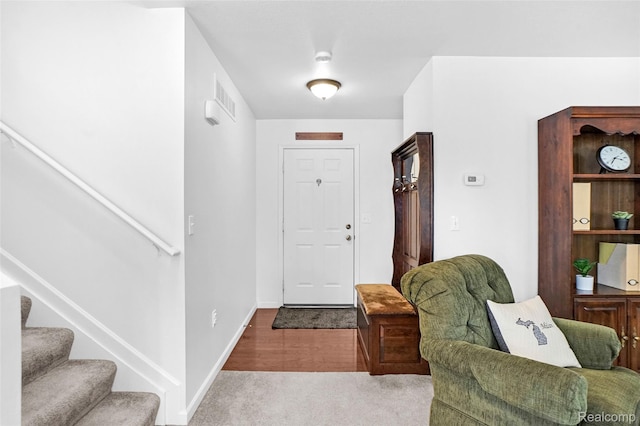 1029 Primrose Ln, Milan, MI 48160 - carpeted entrance foyer with stairway and baseboards