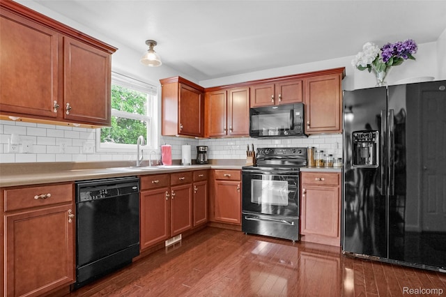1029 Primrose Ln, Milan, MI 48160 - kitchen featuring black appliances, dark wood-style floors, light countertops, and decorative backsplash