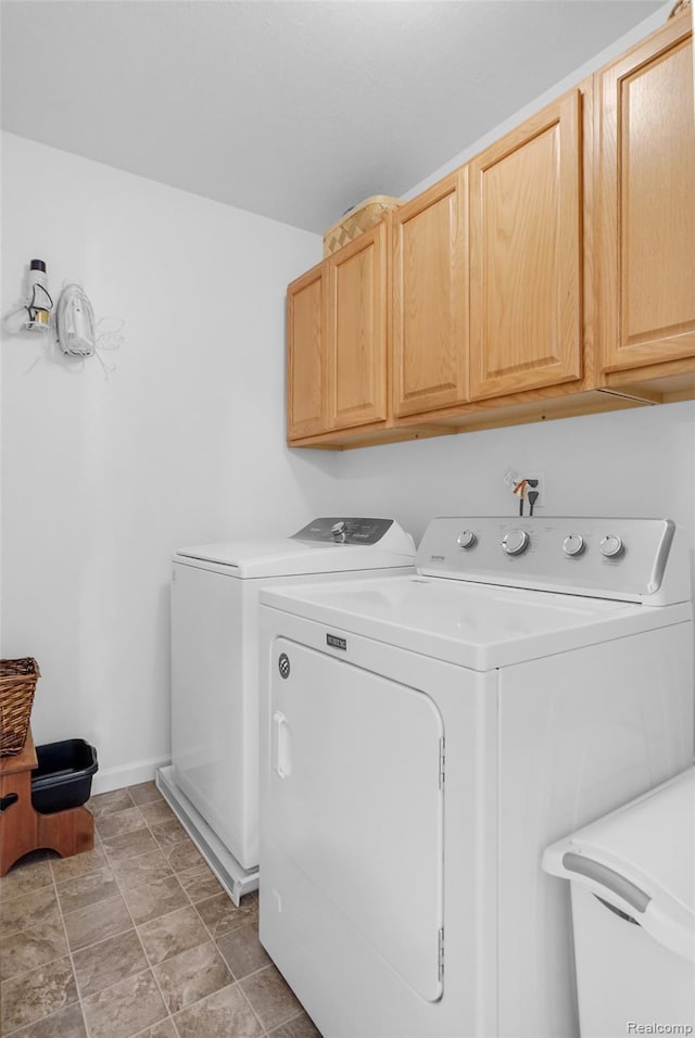 1029 Primrose Ln, Milan, MI 48160 - washroom with cabinet space, washing machine and clothes dryer, and stone finish floors