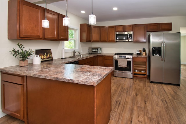 8974 M-140, Berrien Center, MI 49102 - kitchen with appliances with stainless steel finishes, a peninsula, dark wood finished floors, decorative light fixtures, and recessed lighting