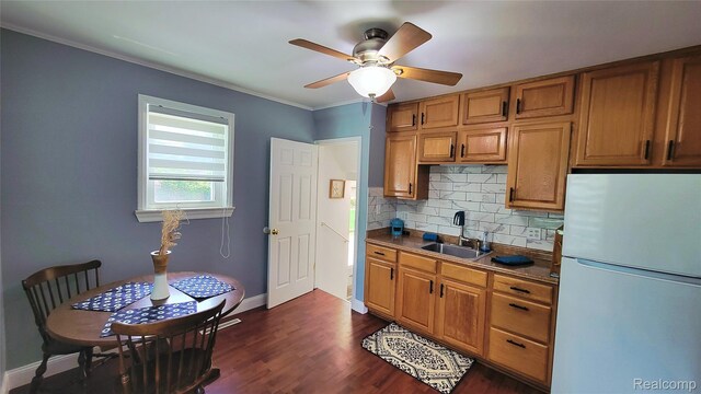 20470 Colman St S, Clinton Township, MI 48035 - kitchen featuring freestanding refrigerator, a sink, backsplash, a ceiling fan, and dark wood finished floors