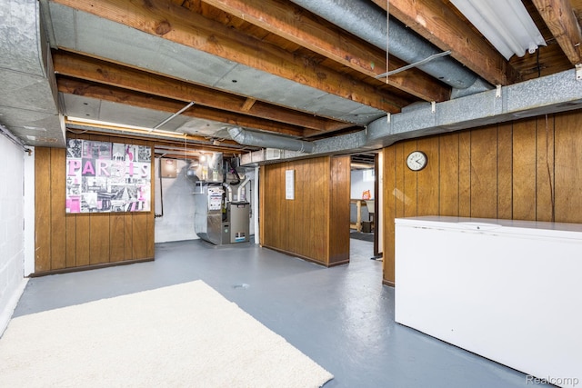 20470 Colman St S, Clinton Township, MI 48035 - basement with fridge, heating unit, and wooden walls