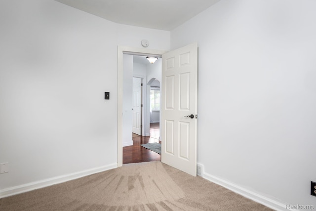 20470 Colman St S, Clinton Township, MI 48035 - carpeted empty room with arched walkways and a smoke detector