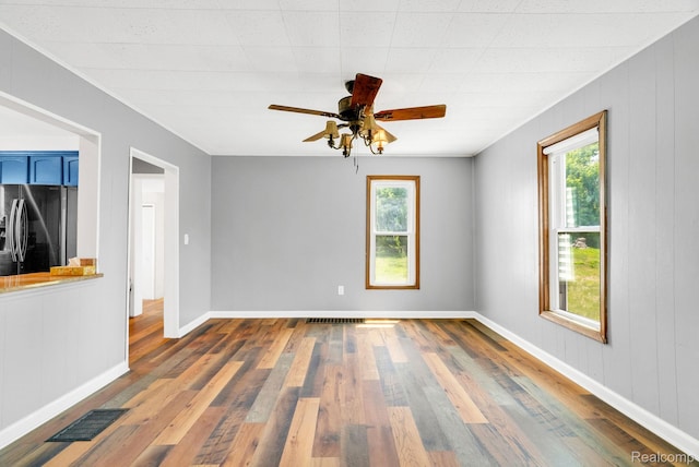 5276 Van Orden Rd, Webberville, MI 48892 - spare room featuring plenty of natural light, wood finished floors, and a ceiling fan