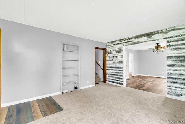 5276 Van Orden Rd, Webberville, MI 48892 - carpeted spare room with baseboards, stairs, wallpapered walls, ceiling fan, and built in features