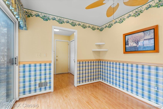 48728 Sundance Ct, Shelby Twp, MI 48315 - empty room with wood finished floors, wainscoting, and a ceiling fan