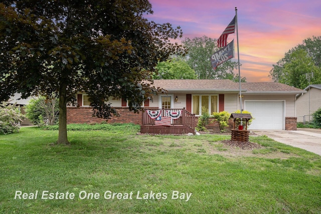 3404 Waldo Ave, Midland, MI 48642 - ranch-style home featuring a garage, concrete driveway, a front yard, brick siding, and a porch