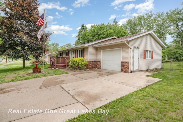 3404 Waldo Ave, Midland, MI 48642 - single story home with an attached garage, driveway, brick siding, and a deck