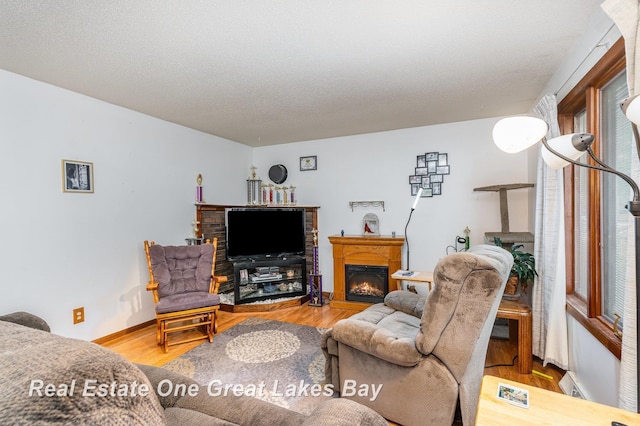 3404 Waldo Ave, Midland, MI 48642 - living room with a warm lit fireplace, wood finished floors, and baseboards