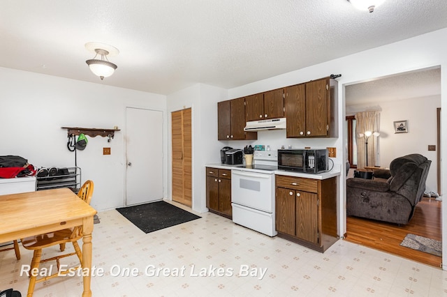 3404 Waldo Ave, Midland, MI 48642 - kitchen featuring white electric range, black microwave, under cabinet range hood, light countertops, and dark brown cabinets