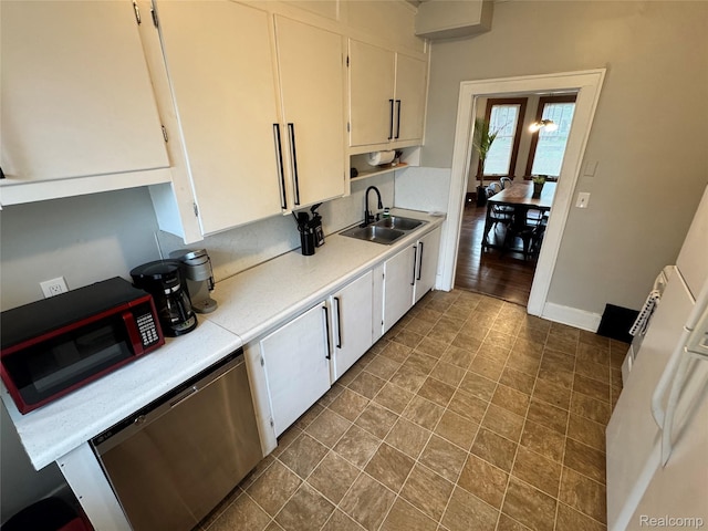1202 Pershing St, Flint, MI 48503 - kitchen featuring dishwasher, light countertops, and white cabinets