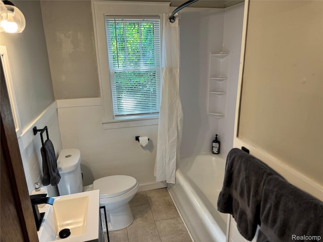 1202 Pershing St, Flint, MI 48503 - bathroom featuring tile patterned floors, plenty of natural light, shower / tub combo with curtain, and a wainscoted wall