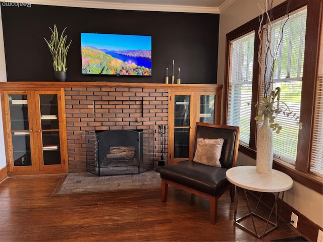 1202 Pershing St, Flint, MI 48503 - sitting room with crown molding, wood finished floors, and a brick fireplace