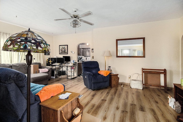 51 Dunning Ave, Battle Creek, MI 49037 - living room with wood finished floors, ceiling fan, arched walkways, baseboards, and an office area